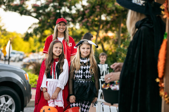 Children Trick Or Treating At A Local Shop
