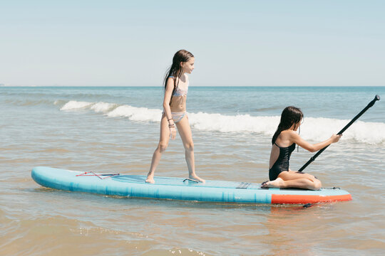 Sisters enjoying with kayak at the sea