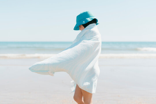 Girl with towel at the beach