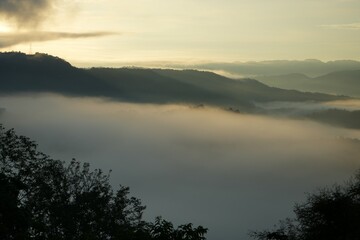 Mountains and clouds are exposed to the light of the morning sun on a high mountain.