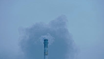 This smoke coming from the chimney in a factory. Harmful emissions into the atmosphere, from the pipe. Serious damage the environment. Plant stack Coaling station. Close up shot. Dark sad view.