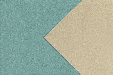 Fototapeta na wymiar Texture of old craft blue paper background, half two colors with light beige arrow. Vintage kraft sand cardboard.