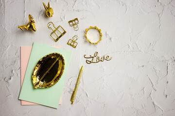 Golden leave with golden pen with colorful notebook, love letter over the white background. 