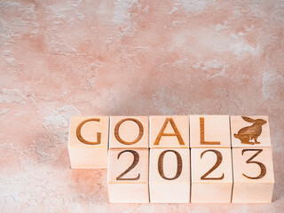 Text 2023 GOALS and the rabbit symbol on wooden cubes as a concept of motivation
