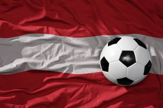 vintage football ball on the waveing national flag of austria background. 3D illustration