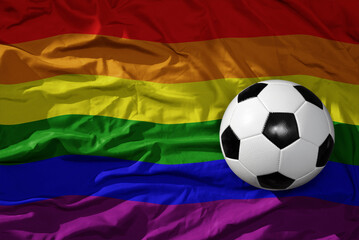 vintage football ball on the waveing rainbow gay flag background. 3D illustration