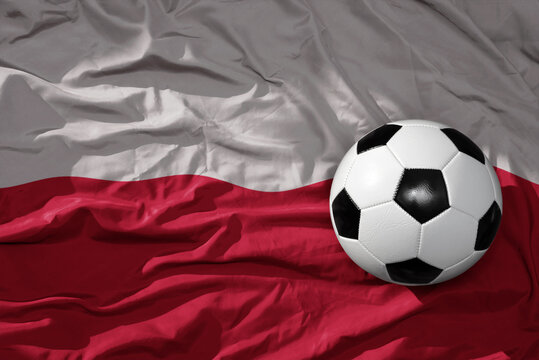 vintage football ball on the waveing national flag of poland background. 3D illustration