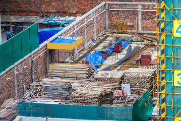 Stacked construction materials and tools at a building site