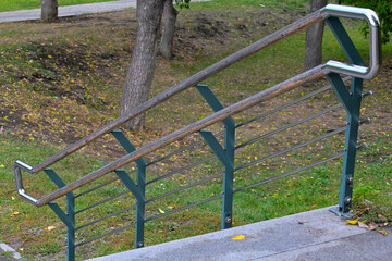 Metal railings of the park stairs on an autumn morning