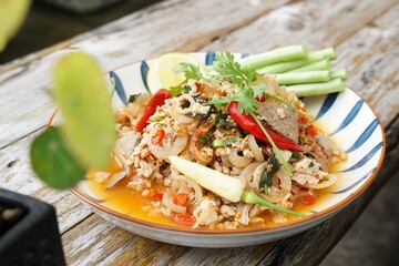 Spicy minced pork salad served with fresh vegetables  Minced pork salad is a popular traditional Thai food of Thailand.  Spicy Minced Pork Salad is also called Larb Moo.