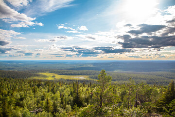 Fototapeta na wymiar Landscape view from the top of Iso-Syöte hilltop with clouds and sky, Lapland, Finland