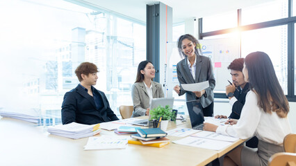 Group of casually dressed asian businesspeople discussing ideas in workspace, Creative...