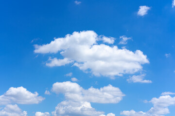 Clear blue sky background with white clouds