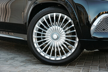 Aluminium rim of luxury black suv car wheel close up