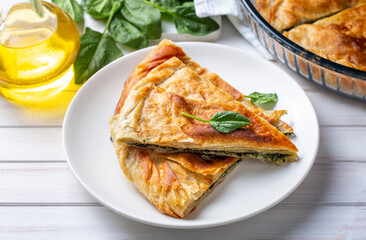 Spanakopita, greek phyllo pastry pie with spinach and feta cheese filling. Delicious handmade pies. Turkish name; el acmasi borek