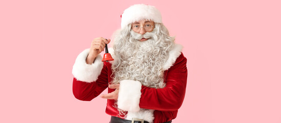 Santa Claus with Christmas bell on pink background
