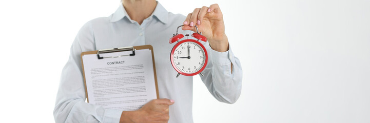 Businesswoman holding contract and alarm clock closeup