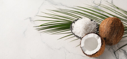 Fototapeta na wymiar Tasty coconut and shavings on light background with space for text