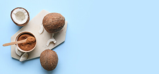 Composition with sweet coconut sugar on light blue background with space for text, top view