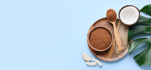 Composition with sweet coconut sugar on light blue background with space for text, top view