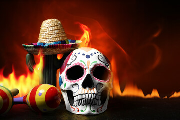 Painted human skull for Mexico's Day of the Dead (El Dia de Muertos), maracas, cactus and sombrero...