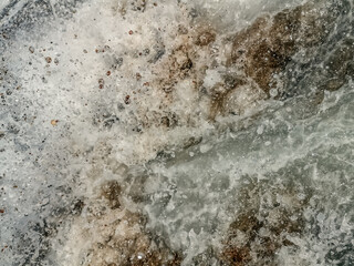 Abstract texture of dirty foamed sea water on the beach. Natural taupe pattern of water splashes...