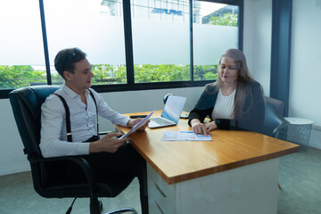 Young professionals having a discussion at a meeting in a modern office on a small conference in the meeting

