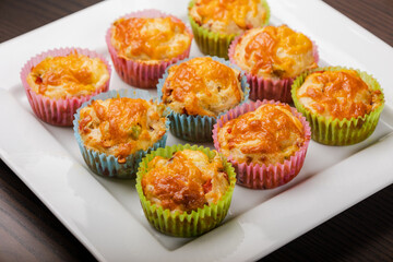 close up of cheesy savory muffins with vegetable 
