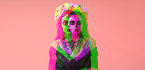 Young woman with painted skull on her face for Mexico's Day of the Dead (El Dia de Muertos) against...