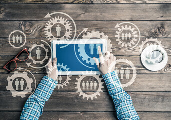 Concept of teamworking and connection with gears mechanism and tablet pc