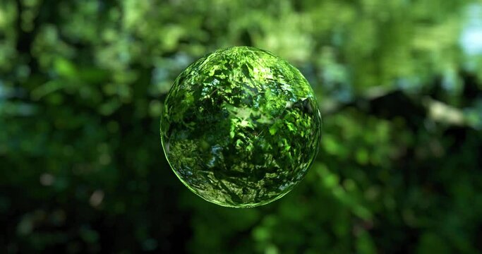 新緑の緑を反射して屈折させた水滴のような球体の回転 水資源・サステナビリティ・sdgs・自然・飲料水・地球・環境・エコロジー・環境のイメージ