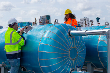 Engineer under industrial inspection Large water heaters are used in high-rise condominiums.