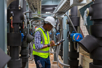 Engineer under industrial inspection Large water heaters are used in high-rise condominiums.

