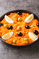 Omek Houria Tunisian Spicy Carrot Salad closeup in the plate on the table. Vertical