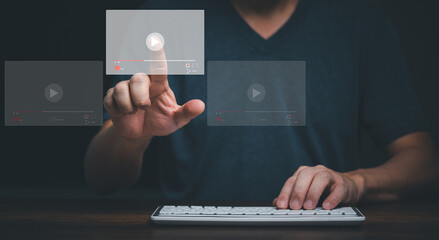 Young man using computer and touching on virtual screen online streaming video on internet.