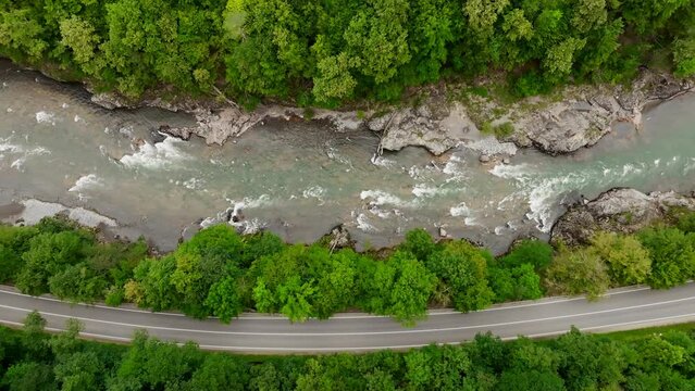 Aerial view of Mountain river and road. Flying over a mountain gorge. Slow motion video, ProRes 422