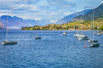 Fototapeta na wymiar Idyllic lake Garda coastline in Malcesine with sailboats, Northern Italy