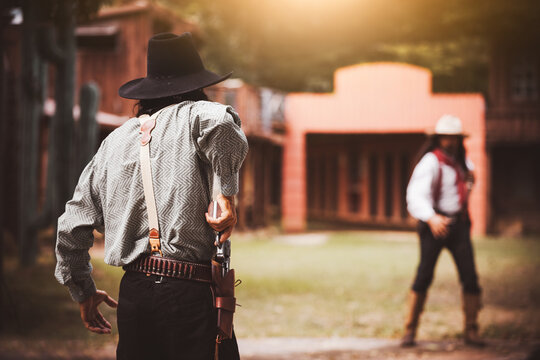 Backside view of cowboy while standing gun prepares on gunfight in cowboys village is cowboy western lifestyle concept.