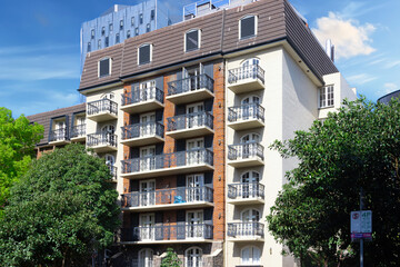 Obraz premium Residential and commercial high rise apartment building in inner Melbourne suburb VIC Australia. Building complex in leafy suburbia great Urban living high density suburban city 