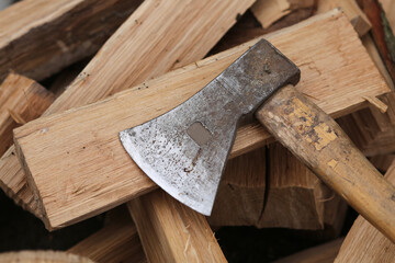 A sharp iron ax for cutting oak firewood.