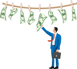 Wet dollar bills hanging on rope