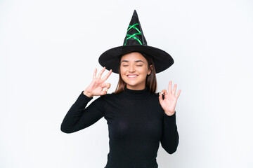 Young caucasian woman costume as witch isolated on white background in zen pose