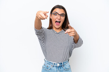 Fototapeta premium Young caucasian woman isolated on white background surprised and pointing front