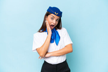 Airplane stewardess caucasian woman isolated on blue background surprised and shocked while looking right