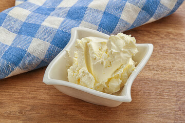 Italian soft mascarpone cheese in the bowl