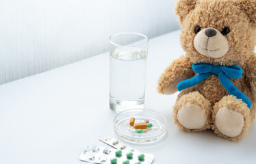 Medicine on table and teddy bear toy Virus treatment concept. healthcare concept. Focus on pills.
