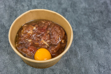 Marinated pork and raw egg for making hot pot in paper cup