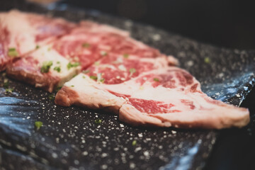 Premium rare sliced beef served for Yakiniku. Close up
