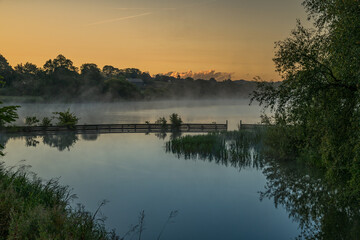 Sunrise in Danish. Mist and haze, with dramatic clouds
