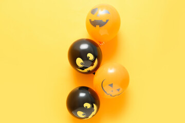 Funny Halloween balloons on yellow background